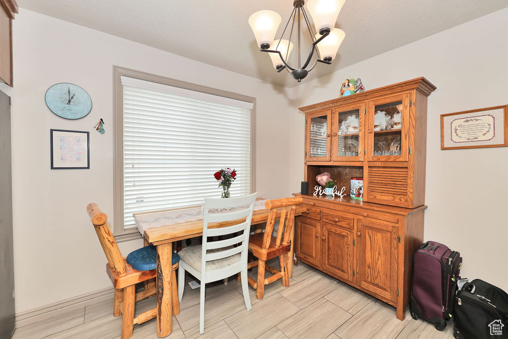 Dining space featuring a chandelier and wood tiled floors