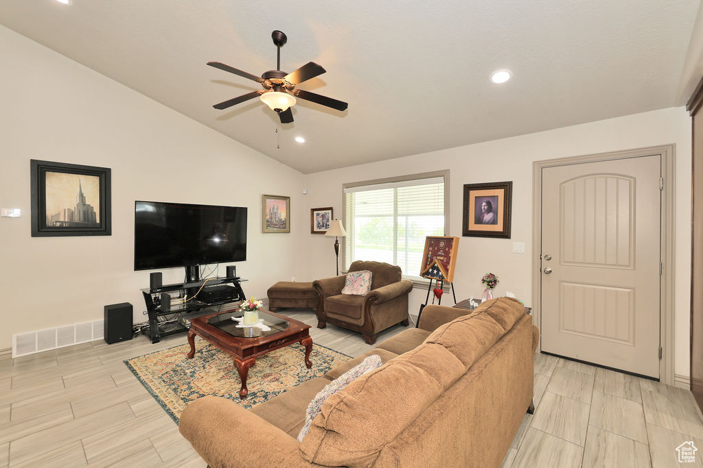 Living area with a ceiling fan, lofted ceiling, recessed lighting, baseboards, and light wood-type flooring
