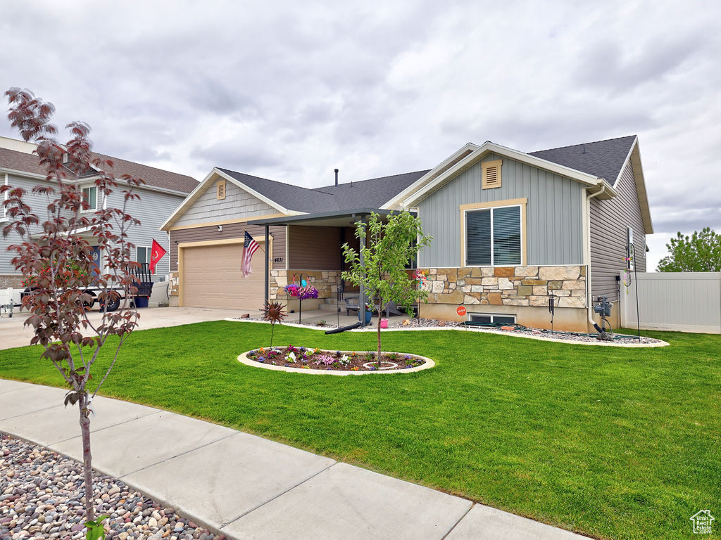 Ranch-style home with board and batten siding, stone siding, driveway, a garage, and roof with shingles