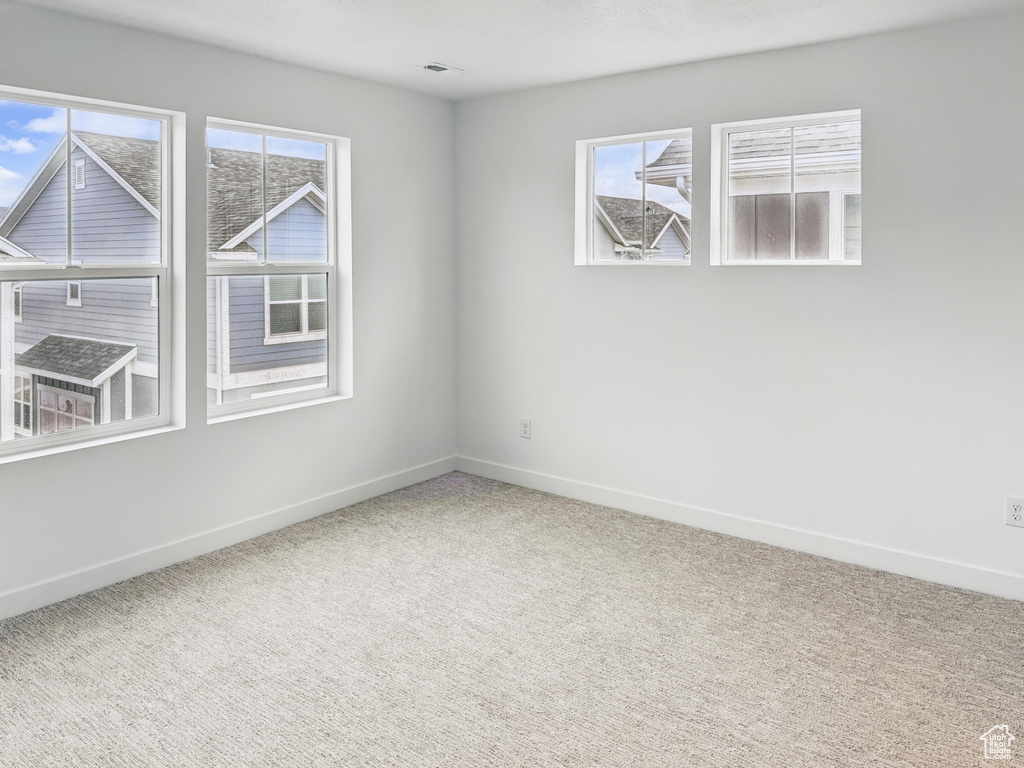 Empty room with carpet floors and baseboards