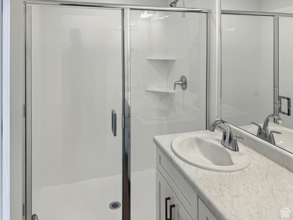 Full bathroom with a shower stall and vanity