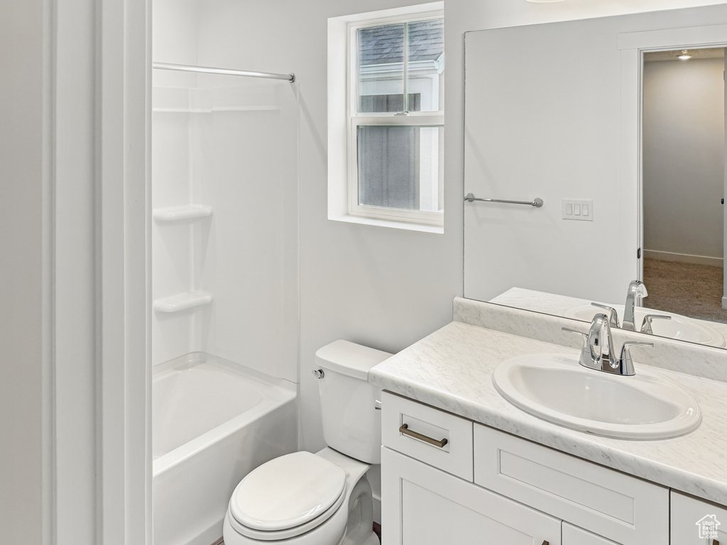 Full bathroom with vanity, toilet, and shower / bathtub combination