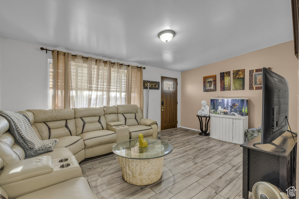 Living area with light wood finished floors and baseboards