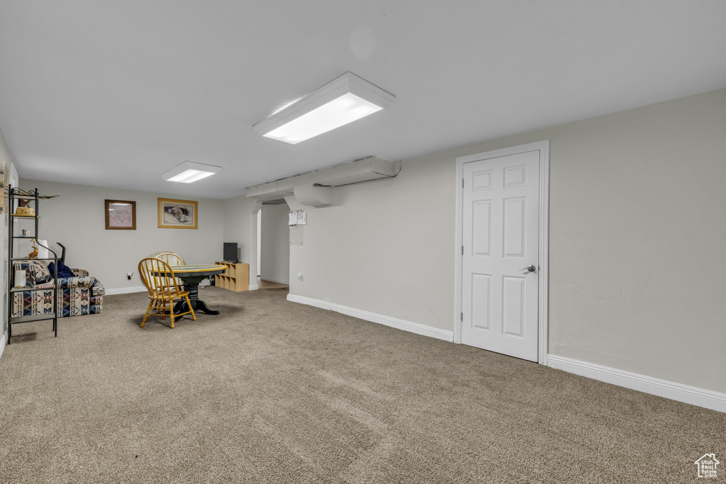 Finished basement featuring carpet floors and baseboards