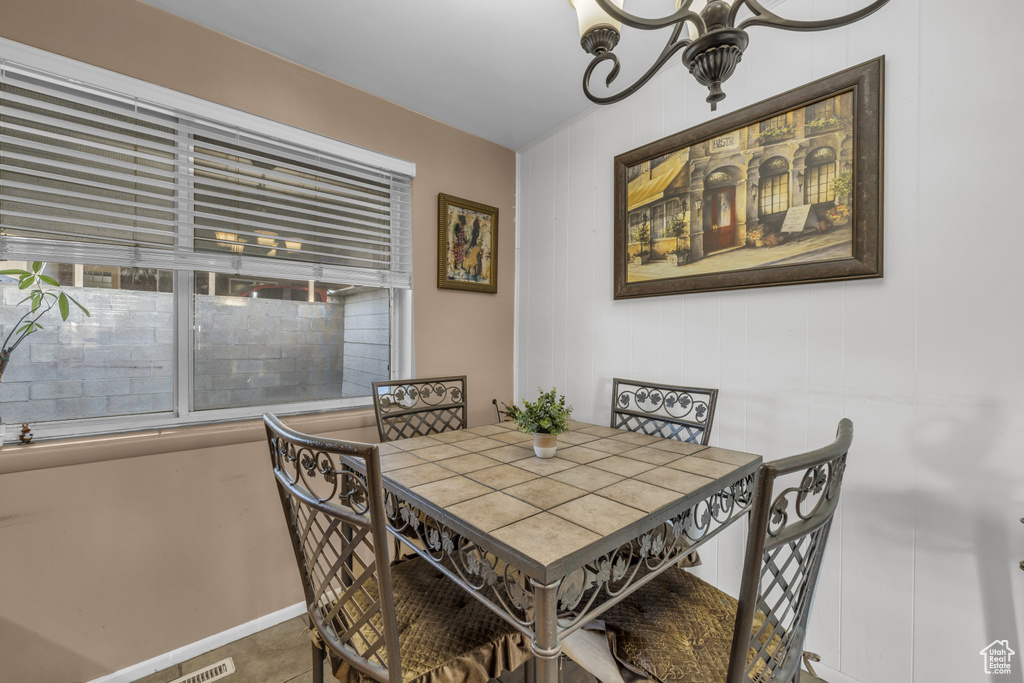 Dining area with a chandelier and baseboards