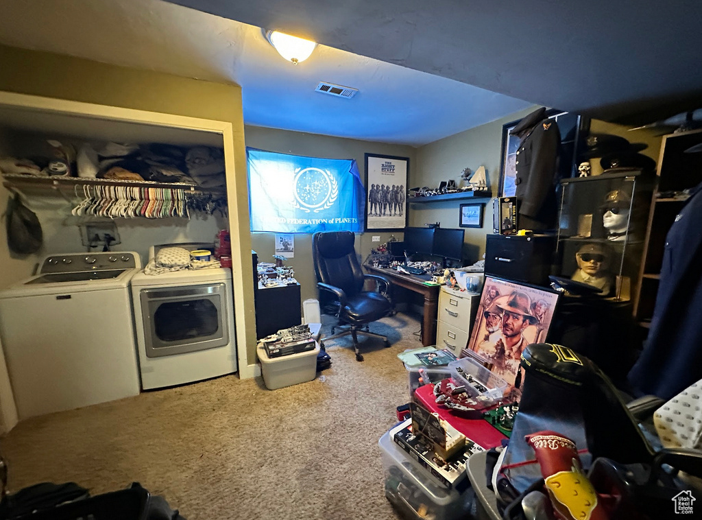 Carpeted office space featuring washer and dryer