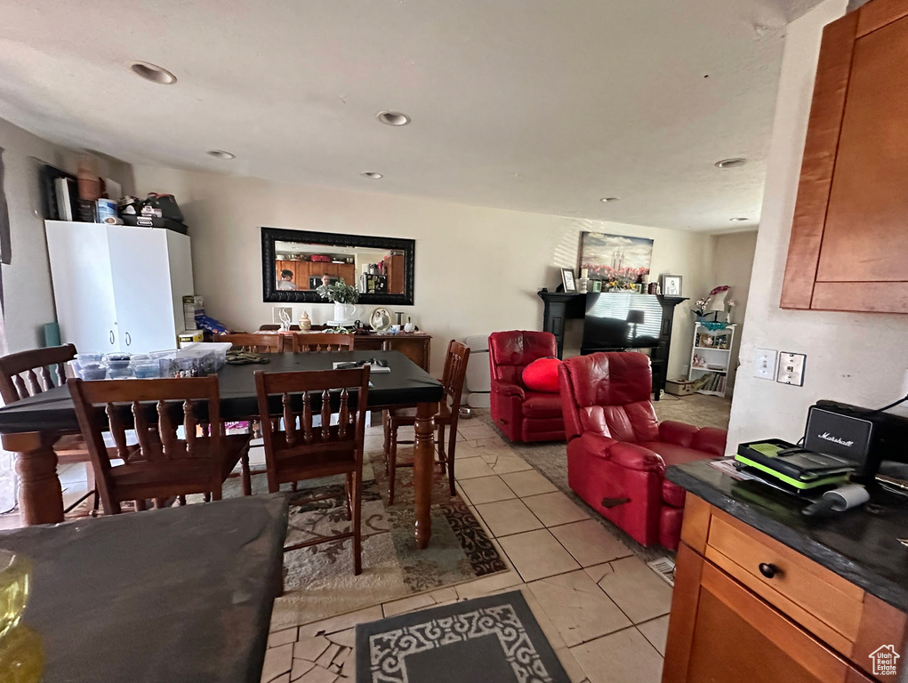 Dining room with light tile patterned floors and recessed lighting