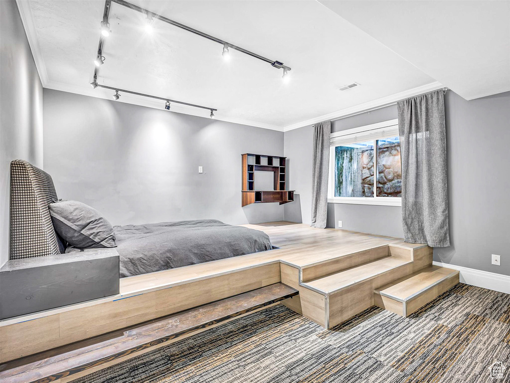 Bedroom featuring ornamental molding and baseboards