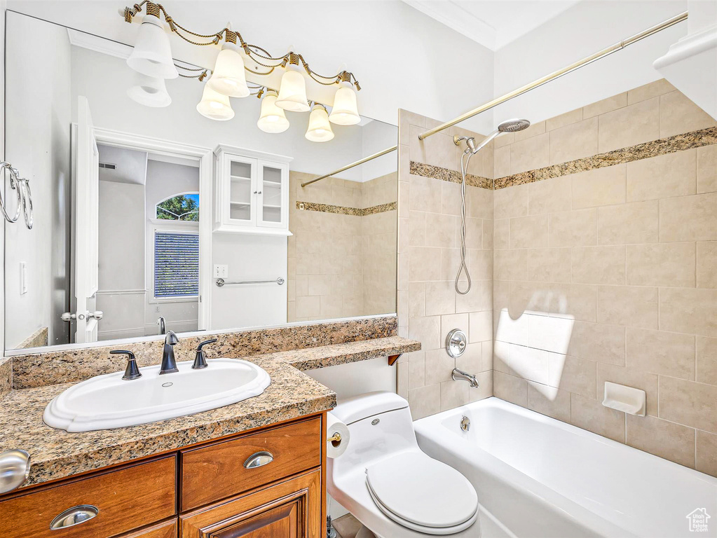 Full bath with shower / tub combination, vanity, and toilet
