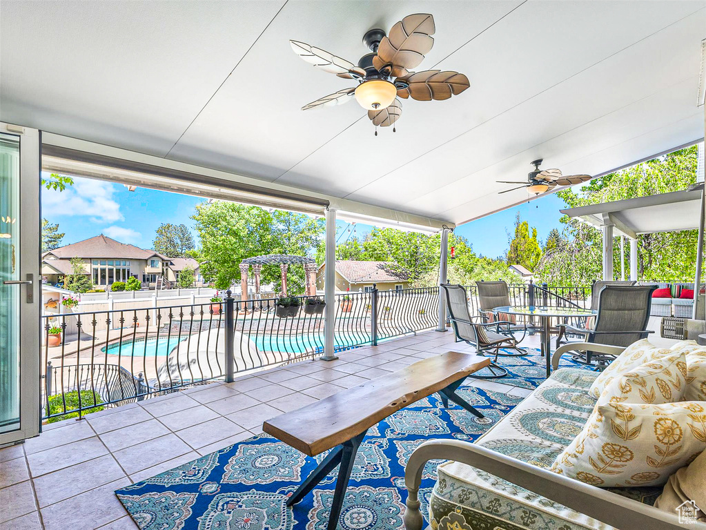 View of patio featuring fence and ceiling fan