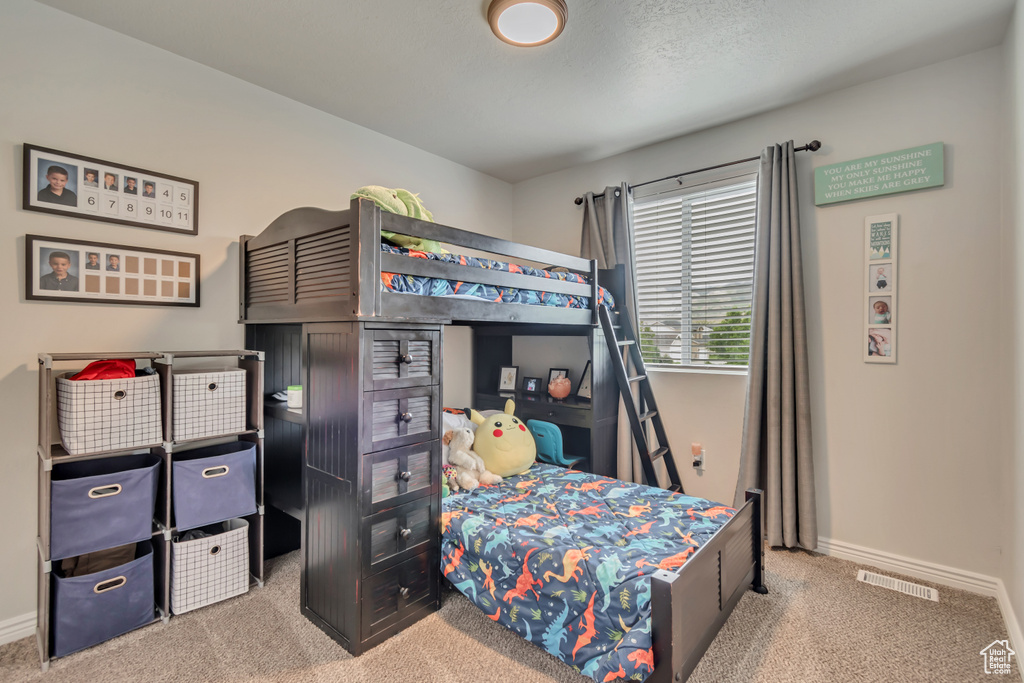 Carpeted bedroom featuring baseboards