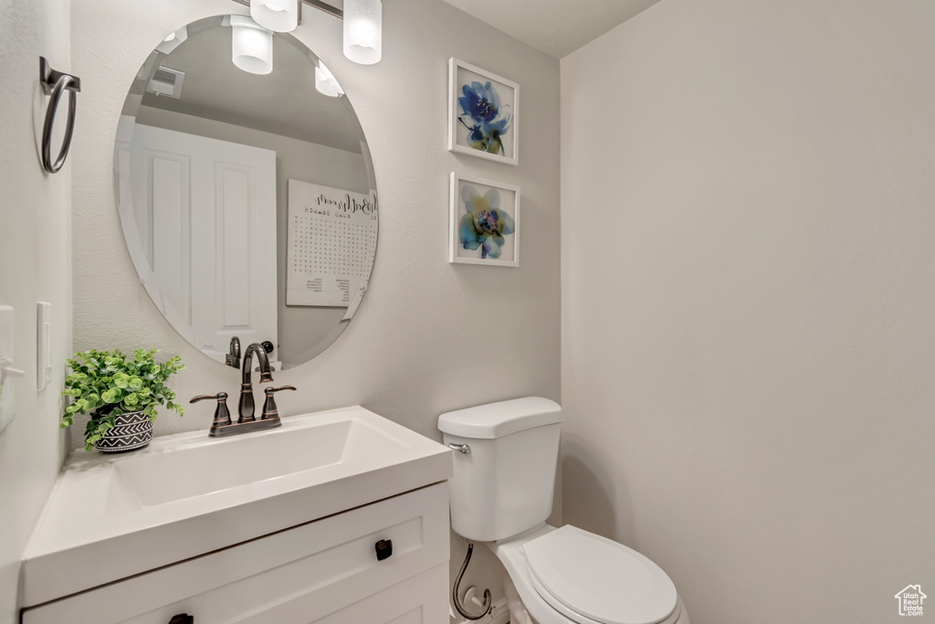 Half bathroom with toilet and vanity