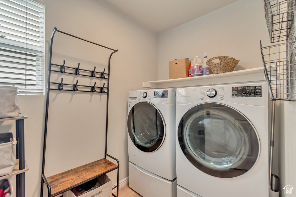 Clothes washing area featuring washing machine and clothes dryer