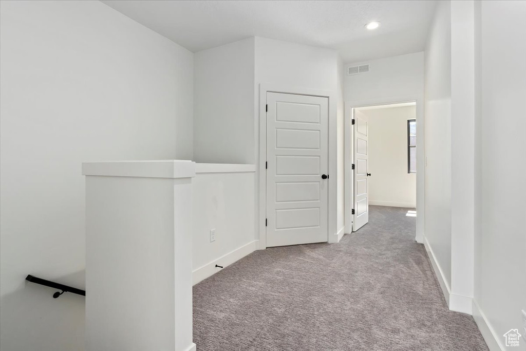 Hallway featuring carpet floors, baseboards, and recessed lighting