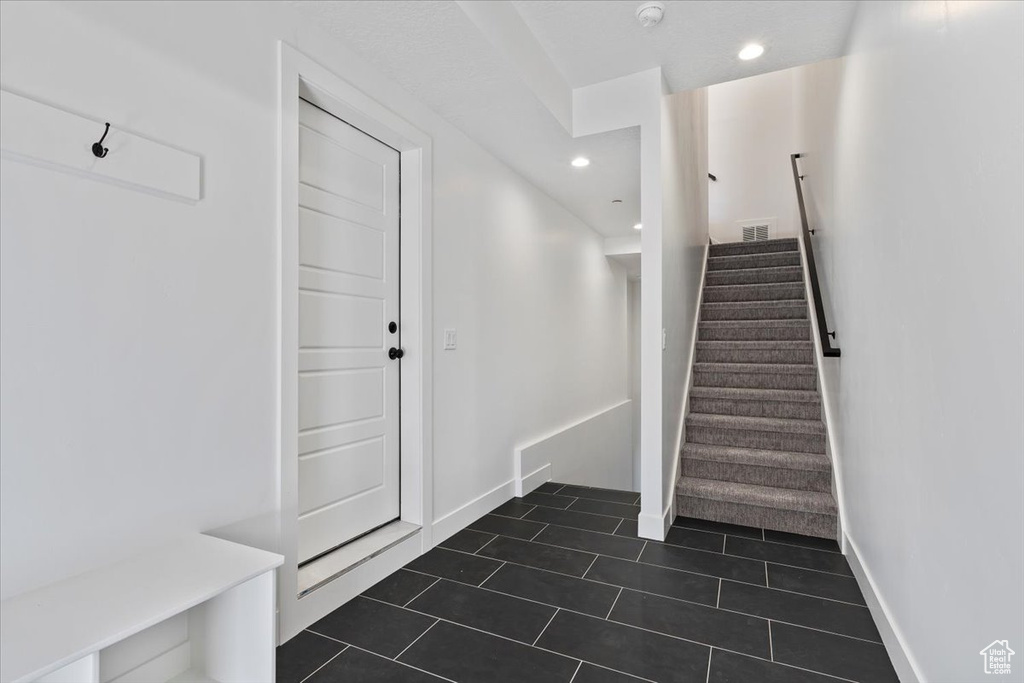 Stairway featuring tile patterned flooring, recessed lighting, and baseboards