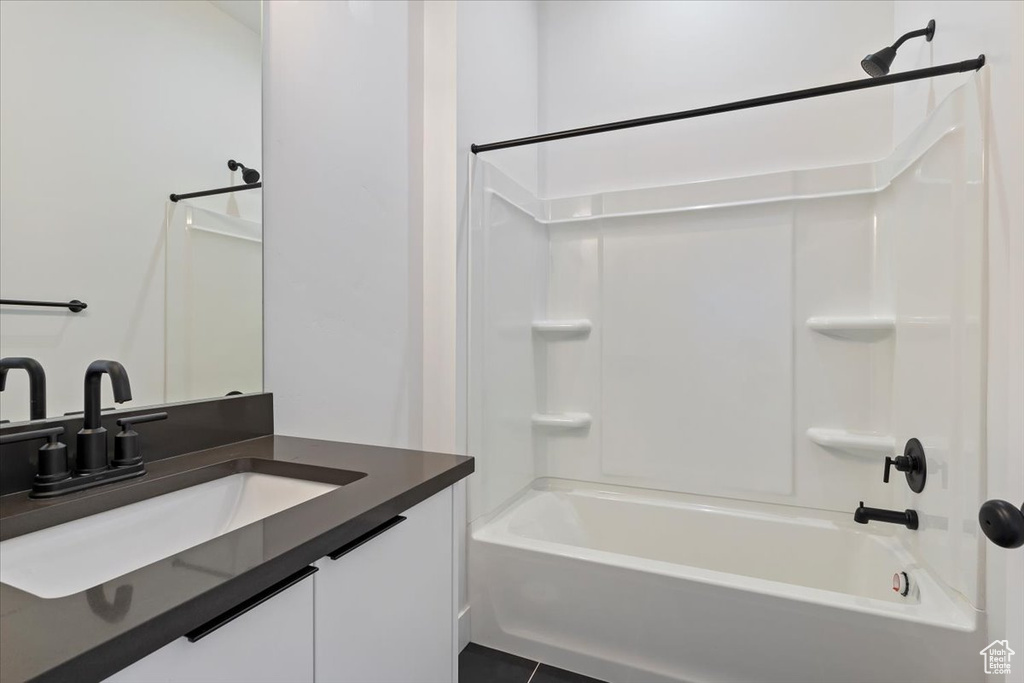 Full bath featuring tub / shower combination and vanity