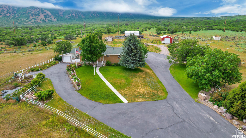 Aerial view of property and surrounding area featuring a forest