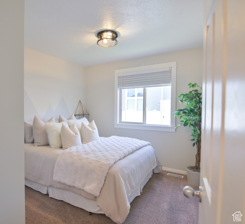 Carpeted bedroom featuring baseboards