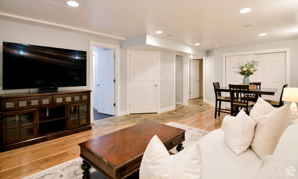 Living area featuring light wood-type flooring, recessed lighting, and baseboards