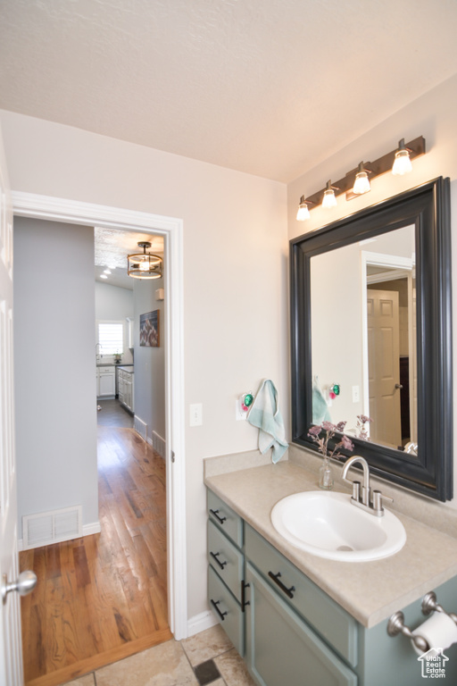 Bathroom featuring vanity and baseboards