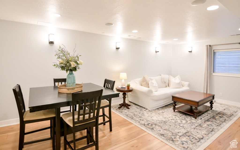 Living area featuring light wood-type flooring, baseboards, and recessed lighting