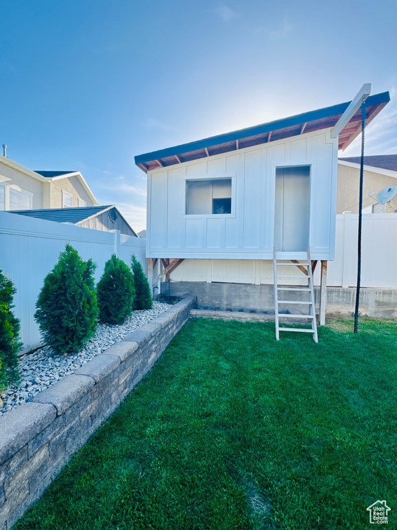 Rear view of house featuring board and batten siding