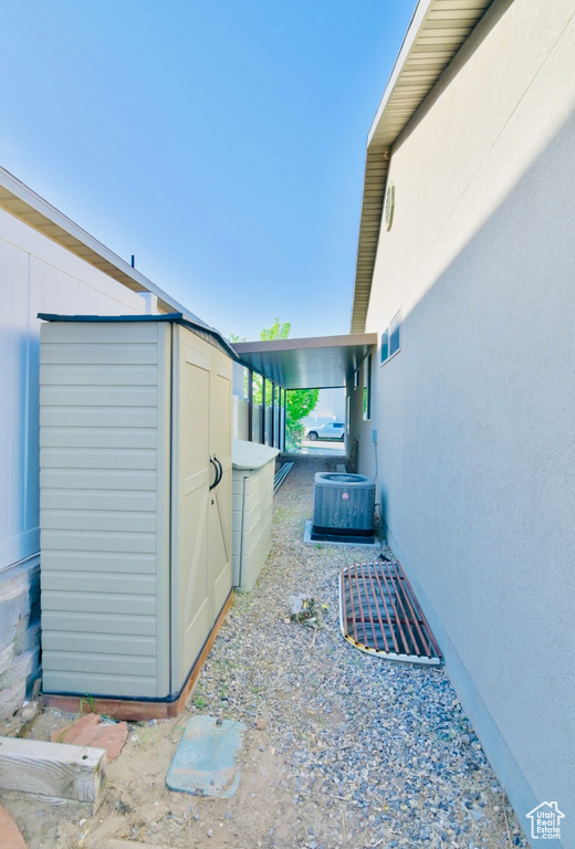 View of property exterior featuring a shed, an outbuilding, and central air condition unit