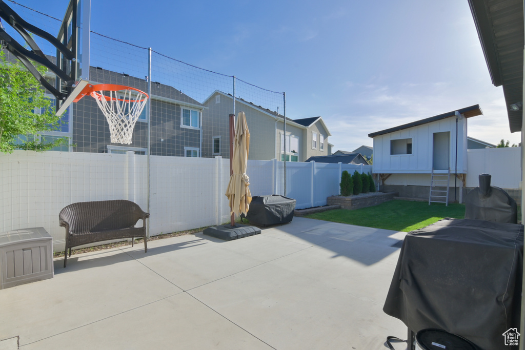 View of patio with a fenced backyard and grilling area