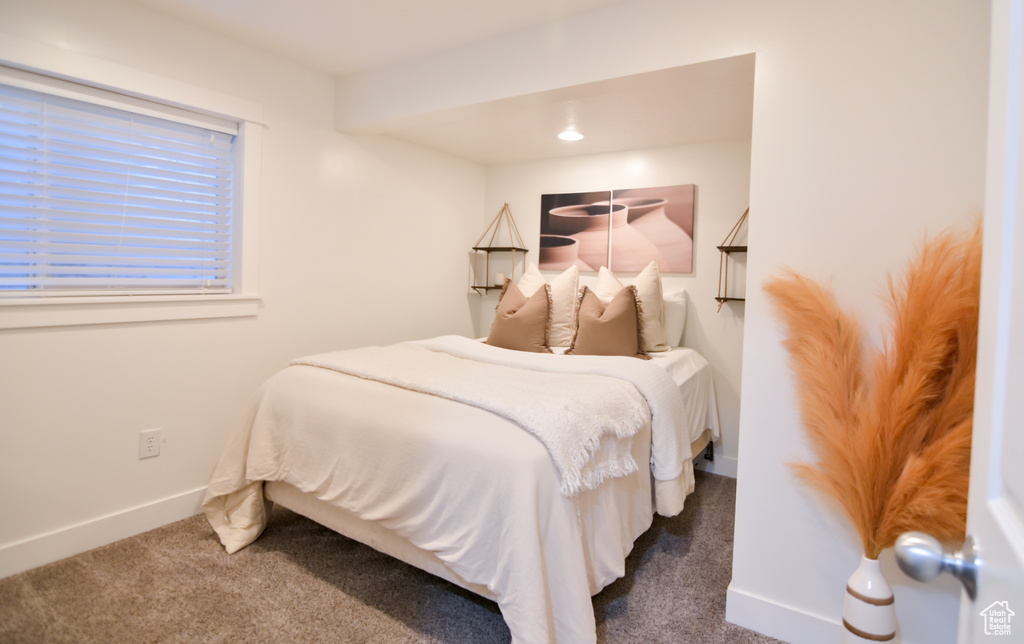 Bedroom featuring carpet floors and baseboards