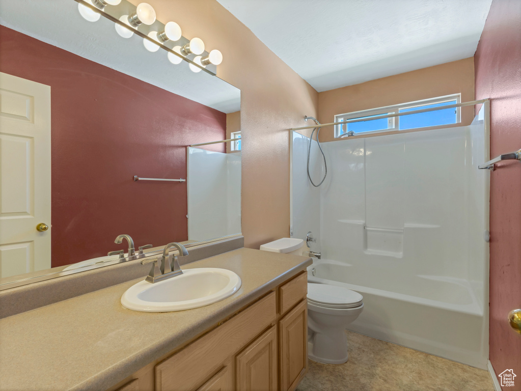 Full bath featuring toilet, vanity, and bathing tub / shower combination