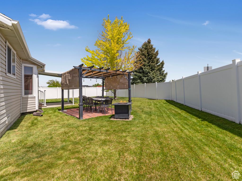 View of yard featuring a pergola and a patio area