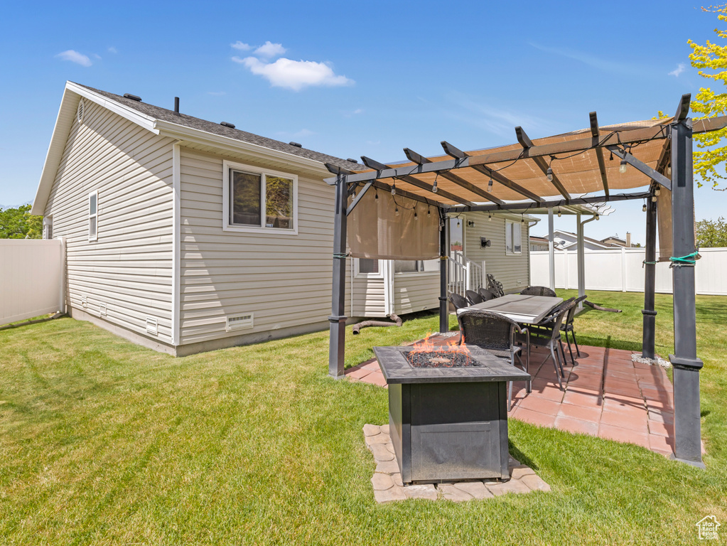 Back of house featuring a fire pit, a pergola, and a patio area