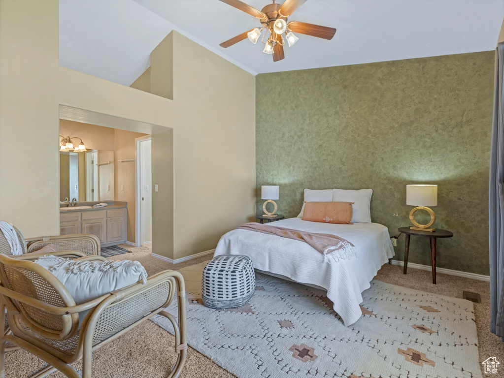 Bedroom with carpet, a chandelier, baseboards, and a high ceiling