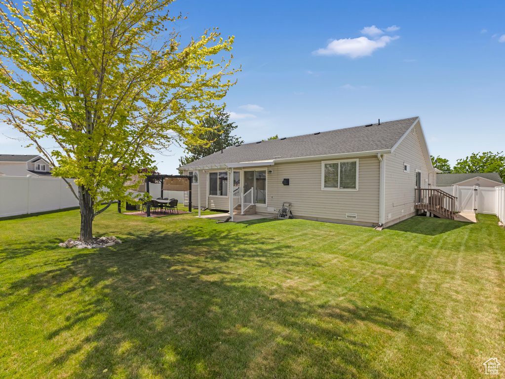 Back of house featuring a patio, entry steps, and a shingled roof