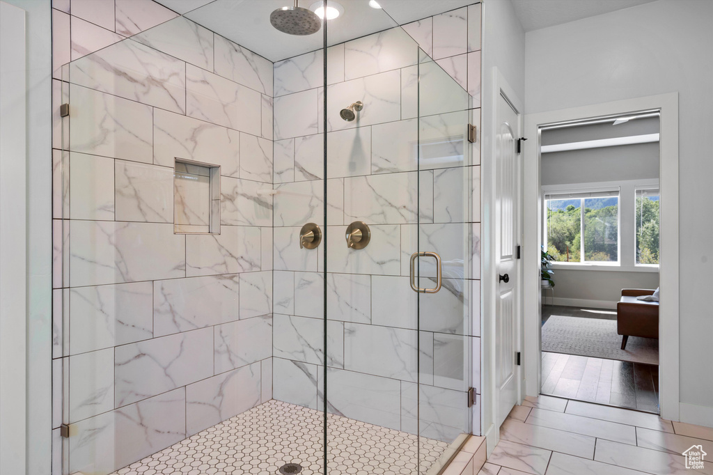 Bathroom with a shower stall, ensuite bathroom, and baseboards