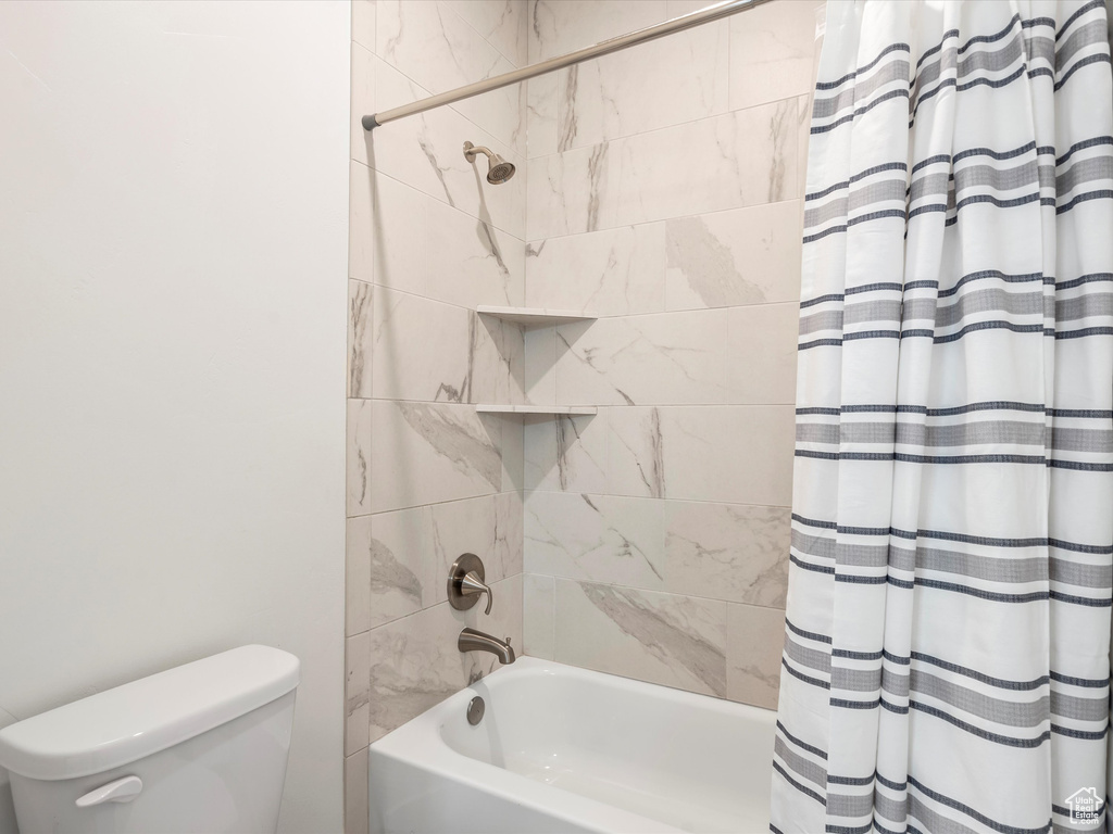Bathroom with shower / bath combo and toilet