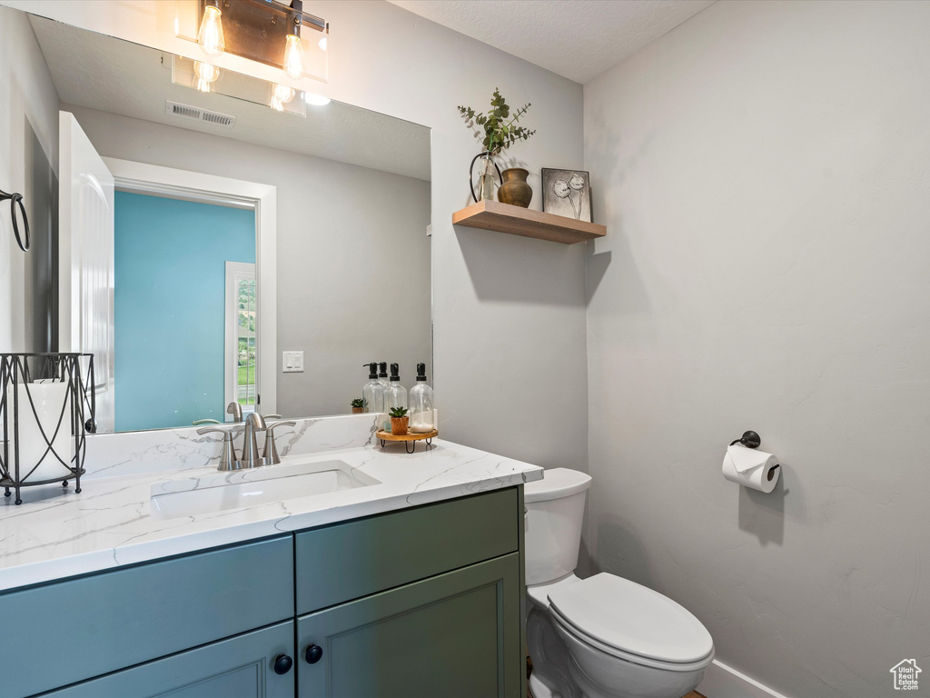 Bathroom featuring toilet and vanity