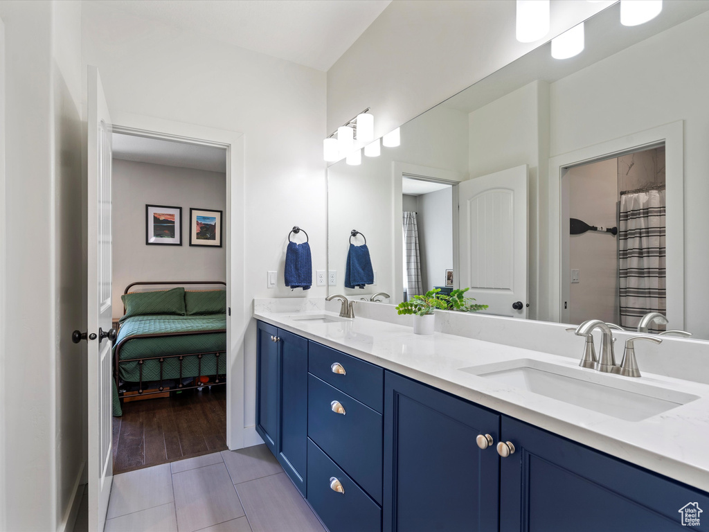 Bathroom with tile patterned floors and double vanity