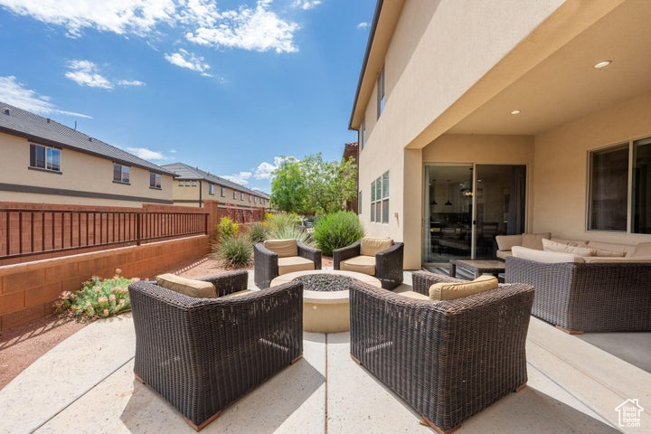 View of patio / terrace with an outdoor living space with a fire pit and a fenced backyard