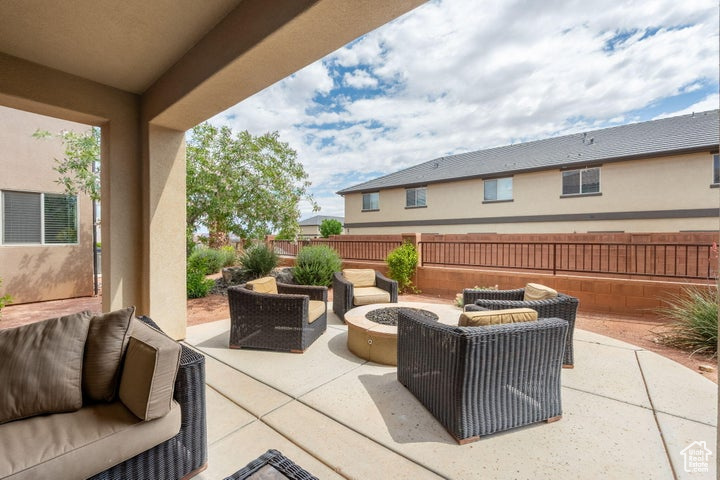 View of patio / terrace featuring an outdoor living space with a fire pit and fence