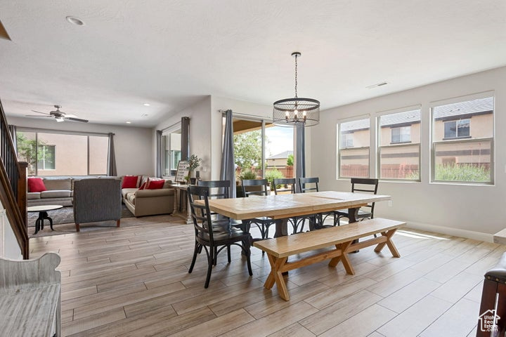 Dining space featuring plenty of natural light, light wood-type flooring, a chandelier, baseboards, and recessed lighting