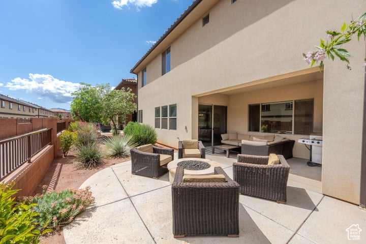 View of patio / terrace with outdoor lounge area, fence, and a grill