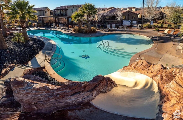 Community pool with a residential view and a patio