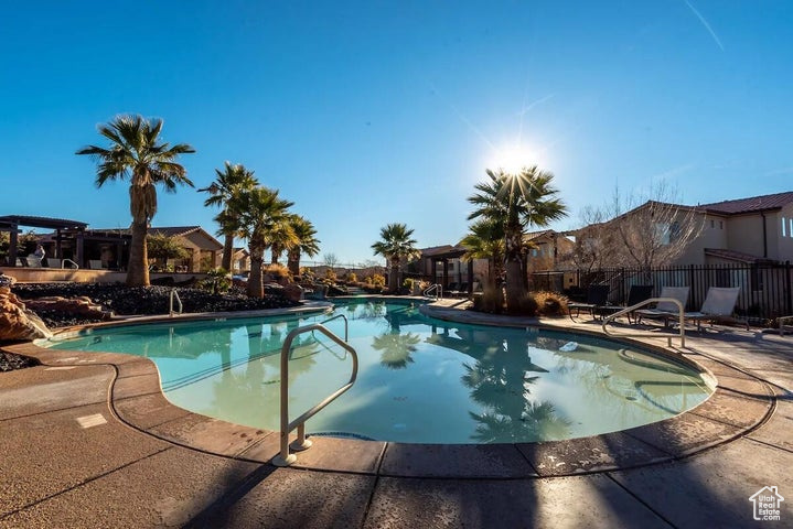 Community pool featuring a patio and fence