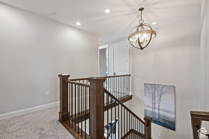Stairs with a chandelier, recessed lighting, carpet floors, and baseboards