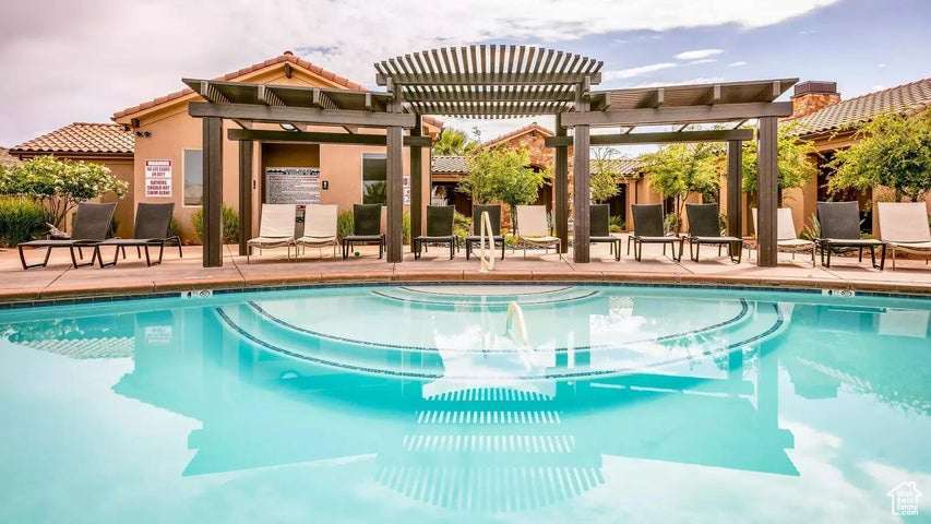 Community pool featuring a pergola and a patio area