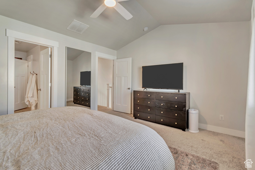 Bedroom with lofted ceiling, carpet floors, baseboards, and a ceiling fan