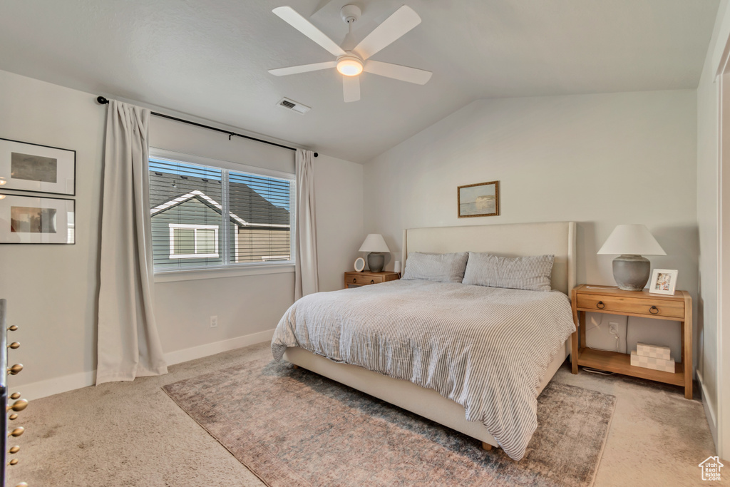 Bedroom with carpet flooring, vaulted ceiling, baseboards, and ceiling fan