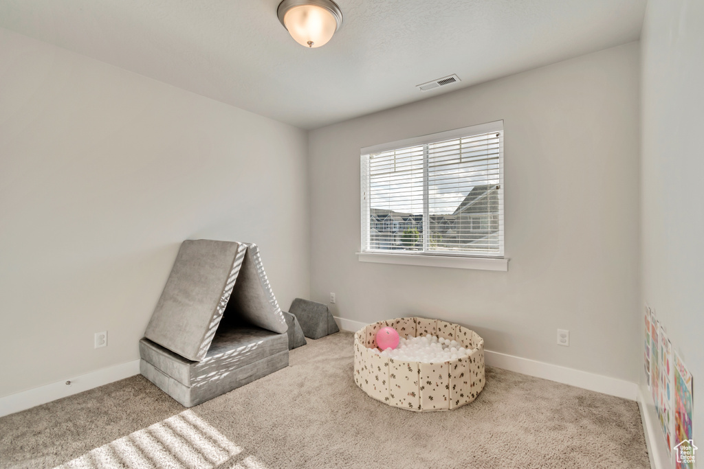 Game room featuring carpet flooring and baseboards
