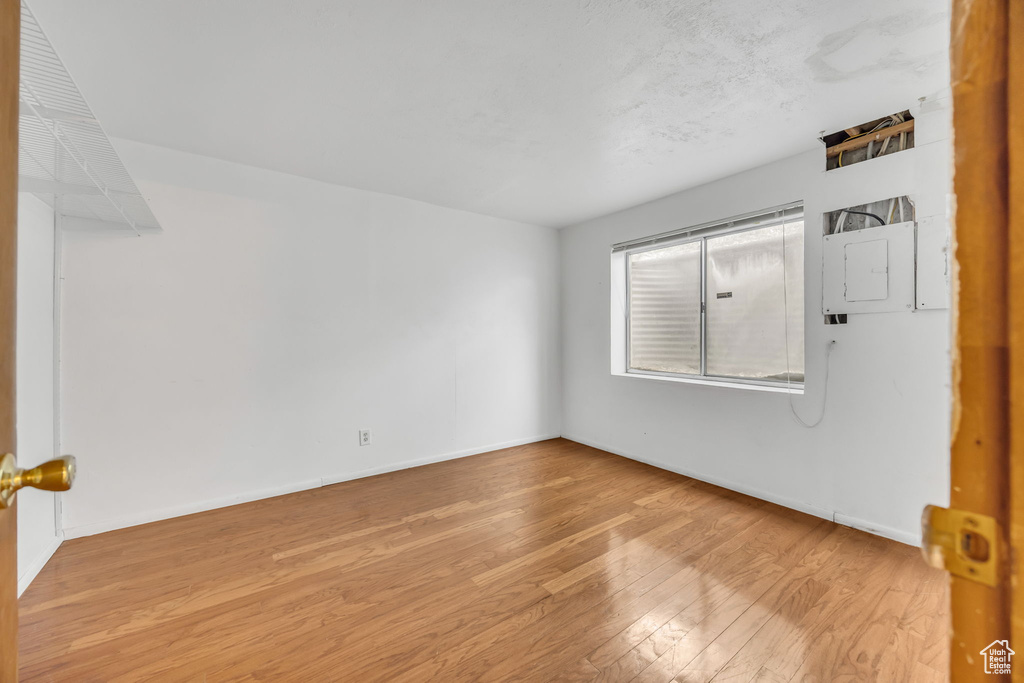 Spare room featuring wood finished floors and baseboards